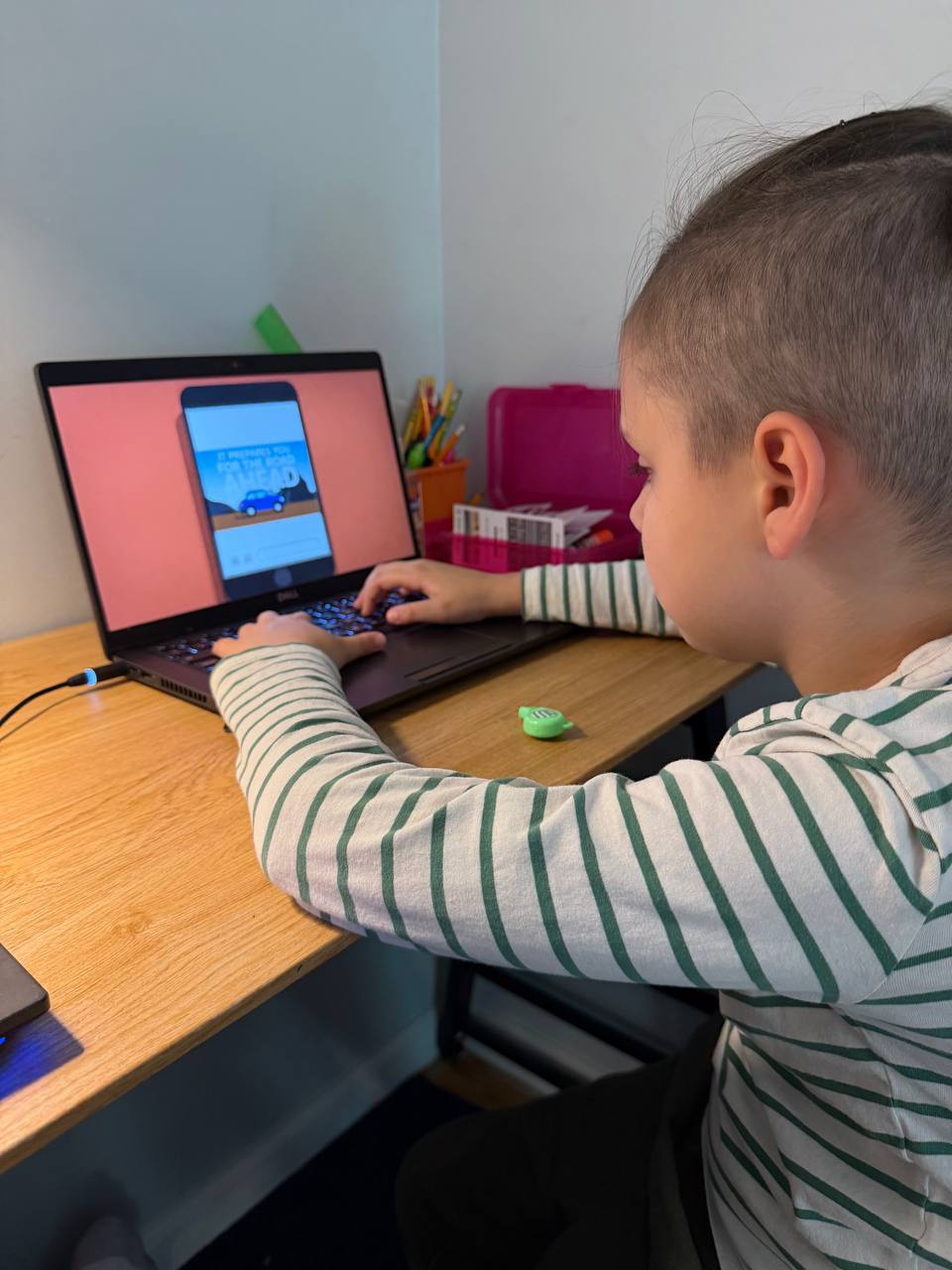 Young student testing a game project on a laptop at home